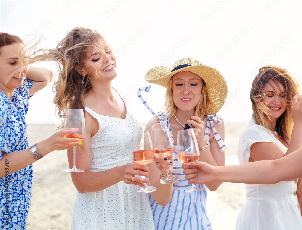 Cheerful women proposing toast on beach Cheerful women proposing toast on beach