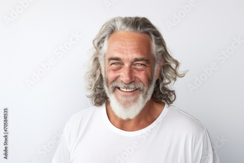 Smiling portrait of a bearded middle aged man on white background © Vorda Berge