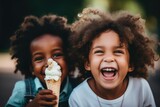 Happy diverse children eating ice cream cones outside