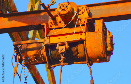 Lifting motor gear of a rusty, abandoned industrial crane structure