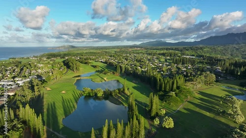 Aerial Kauai Princeville golf resorts ocean mountain afternoon 2. Expensive luxury homes, resort, condominium and golf club near coast. Recreation and tourism. Economy tourism. Warm tropical climate. photo