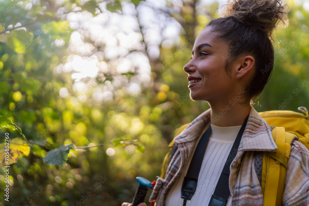A curly-haired forest wanderer, enjoying the serene atmosphere of an autumn forest trail, accompanied by her trusty binoculars. A curly-haired forest wanderer, enjoying the serene atmosphere of an autumn forest trail, accompanied by her trusty binoculars.