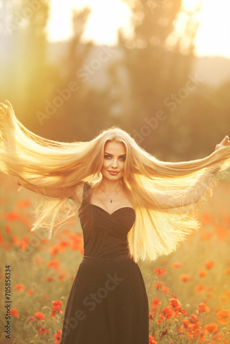 Wallpaper Mural Beautiful brunette woman in a black dress with a bouquet of flowers in a poppy field Torontodigital.ca