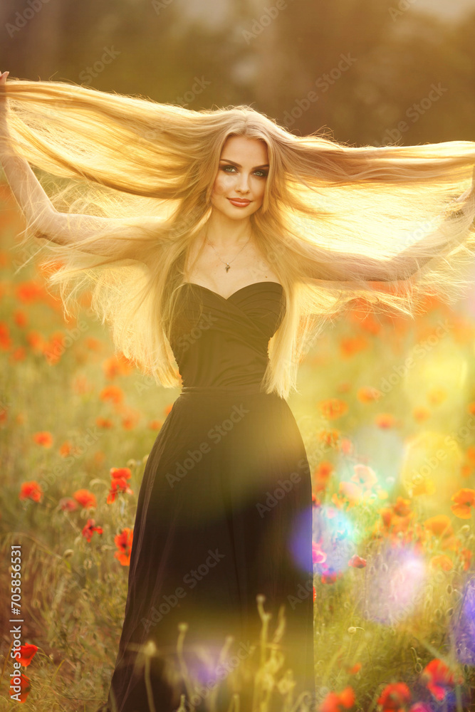 Beautiful brunette woman in a black dress with a bouquet of flowers in a poppy field Beautiful brunette woman in a black dress with a bouquet of flowers in a poppy field