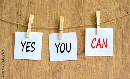 Motivational and Yes you can symbol. Concept words Yes you can on beautiful white paper on clothespin. Beautiful wooden table wooden background. Business motivational Yes you can concept. Copy space.