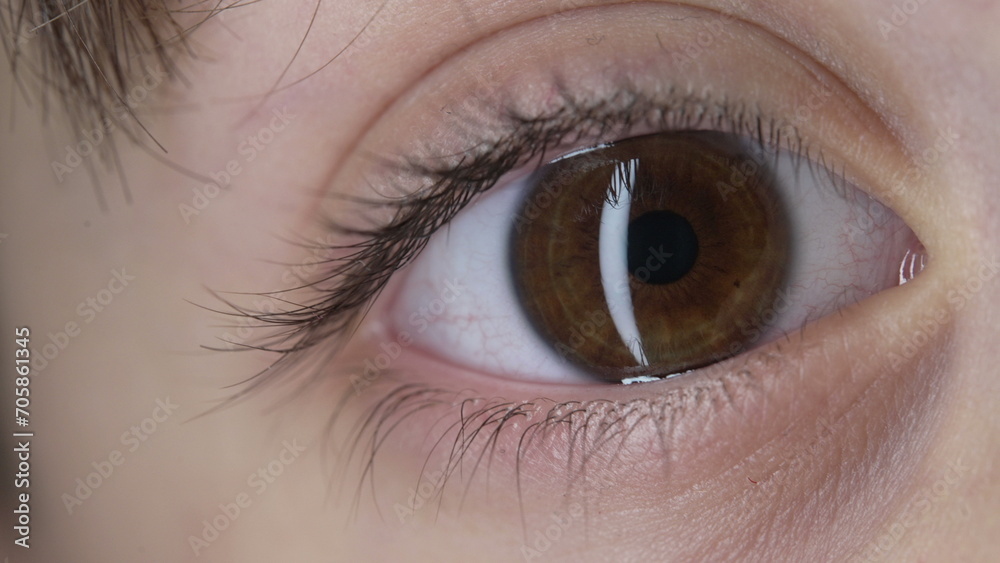 Fototapeta premium Child's eye captured in macro close-up gazing at camera. Iris retina tight closeup