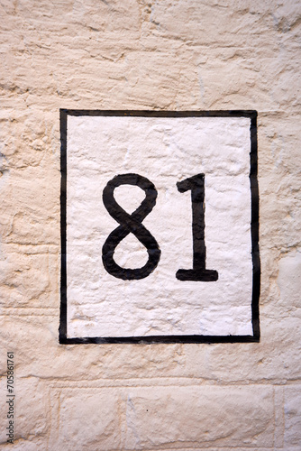 Close up of an house door number 81