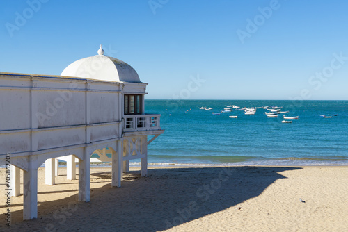The famous beach Playa de la Caleta with little boats in the background in Cadiz, Spain