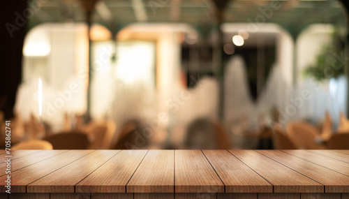  Empty wooden table top with lights bokeh on blur restaurant background. 