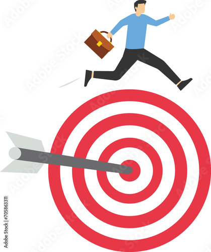 Skilled successful businessman jumping over arrow hitting bullseye target. Reaching target, achievement, mission success or victory concept, achieving goals or getting business goals and objectives.
