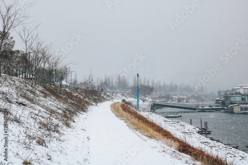 Snowy pathway next to Han river in the songpa-gu district in Jamsil Hangang Park, Seoul, South Korea on winter season. Cold winter in Korea.