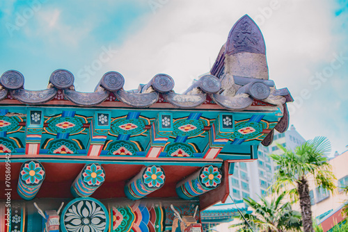Close up of tile roof and Dancheong of the fortress of Gyeongbokgung Palace, Seoul, South Korea. Details of the Korean traditional Palace roofs on a sunny day. Beautiful korean style wallpaper.