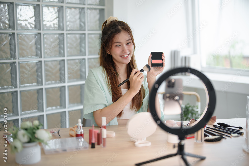 Female beauty blogger Influencer filming cosmetics makeup or comparing review on live stream..