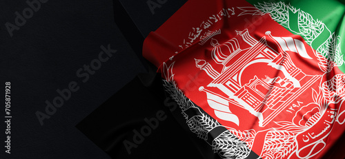 Flag of Afghanistan. Fabric textured Afghanistan flag isolated on dark background. 3D illustration photo