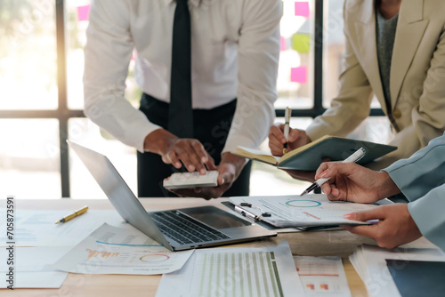 Business representatives meeting pointing on laptop computer. Business team discussing investment plan using data on laptop.