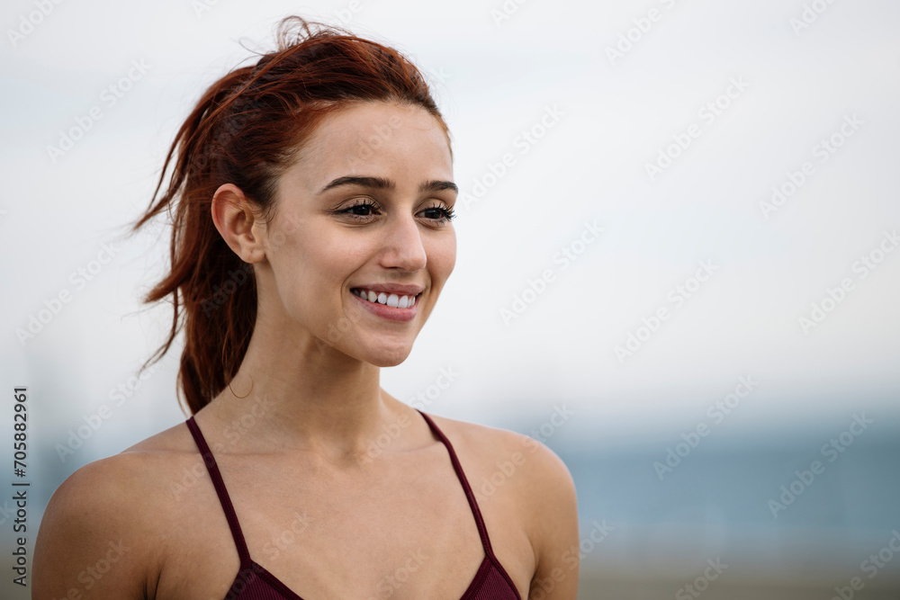 Lovely fit woman joyful close up outside. Sport runner female smiling satisfied in sportswear. Lovely fit woman joyful close up outside. Sport runner female smiling satisfied in sportswear.