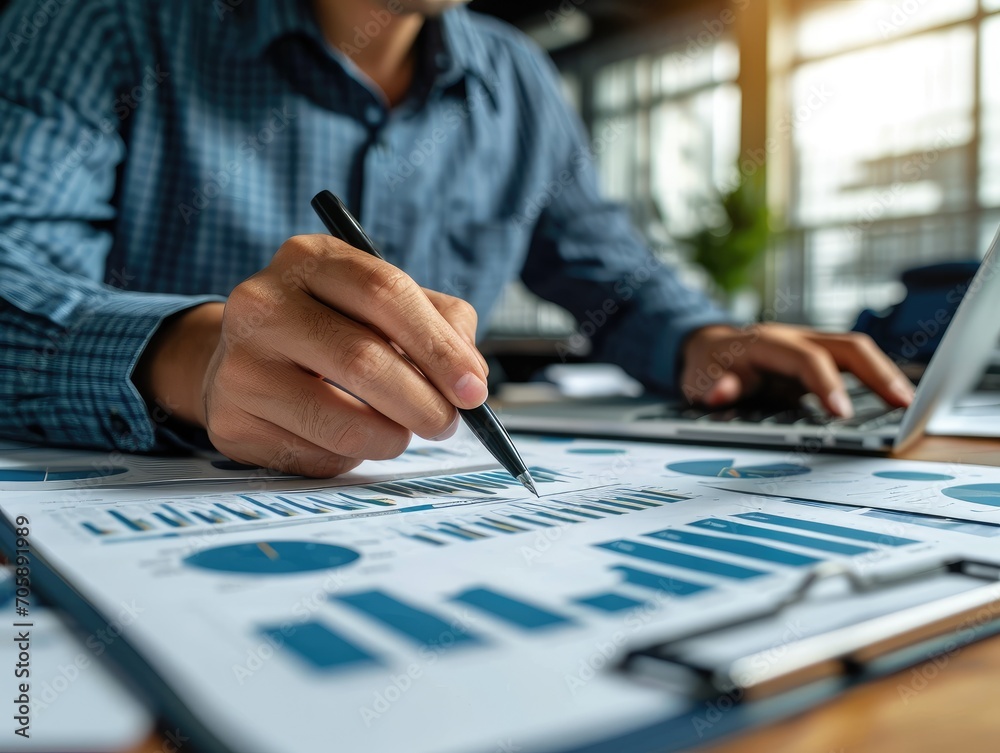 Fototapeta premium Financial analyst man working on data analysis and charts in a contemporary business environment.