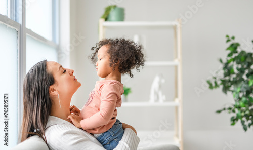 Mother with little daughter at home sofa © Louis-Photo