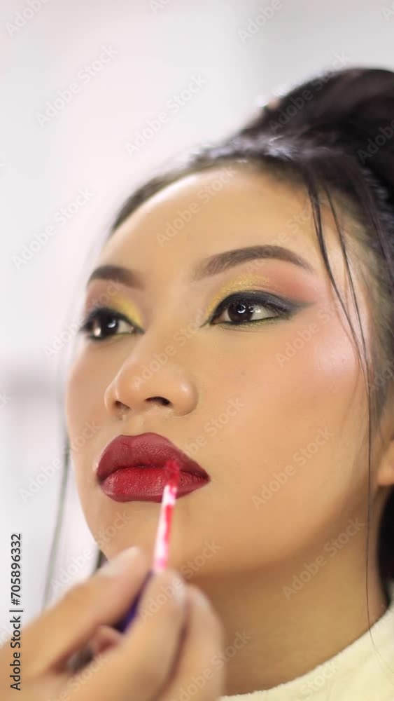 Video of young girl being made up, painting her lips. Concept of people and beauty. Video of young girl being made up, painting her lips. Concept of people and beauty.