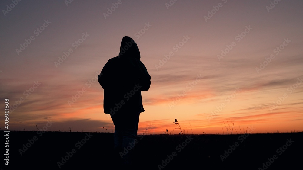 silhouette of a sporty running man, physically fit man, active activity at sunset, sports lifestyle, jogging alone, sprinting outdoors, endurance active sports man running, sportive energy of youth,