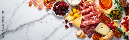 cured meats and cheeses, charcuterie. on white marble, copy space banner