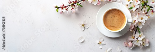 Cup of espresso with spring cherry blossoms on white background. Flat lay composition with space for text. Serene morning concept. Design for menu, poster, invitation, greeting card photo