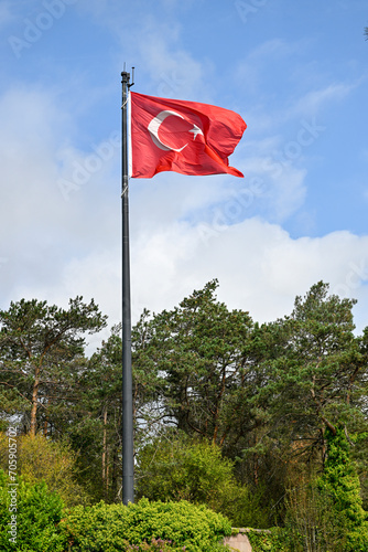 Turkish flag against cloudy sky 
