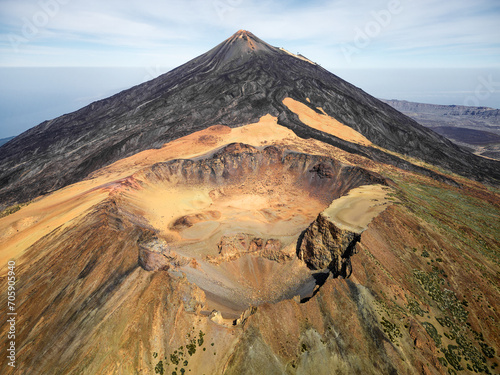 Aerial view of Pico Viejo volcano with Mount Teide in the background in Tenerife, Canary Islands, Spain. Pico Viejo has a spectacular 800 meters diameter crater. Famous destinations for hikers. photo
