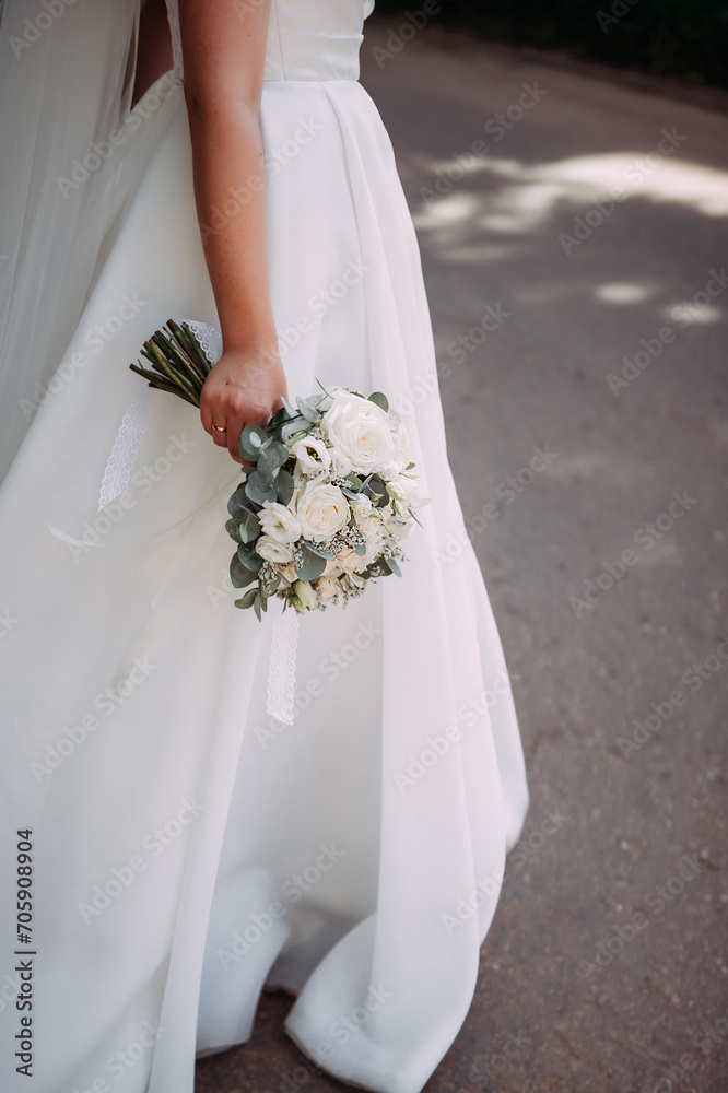 A woman in a white wedding dress holding a bouquet of flowers 5330. A woman in a white wedding dress holding a bouquet of flowers 5330.