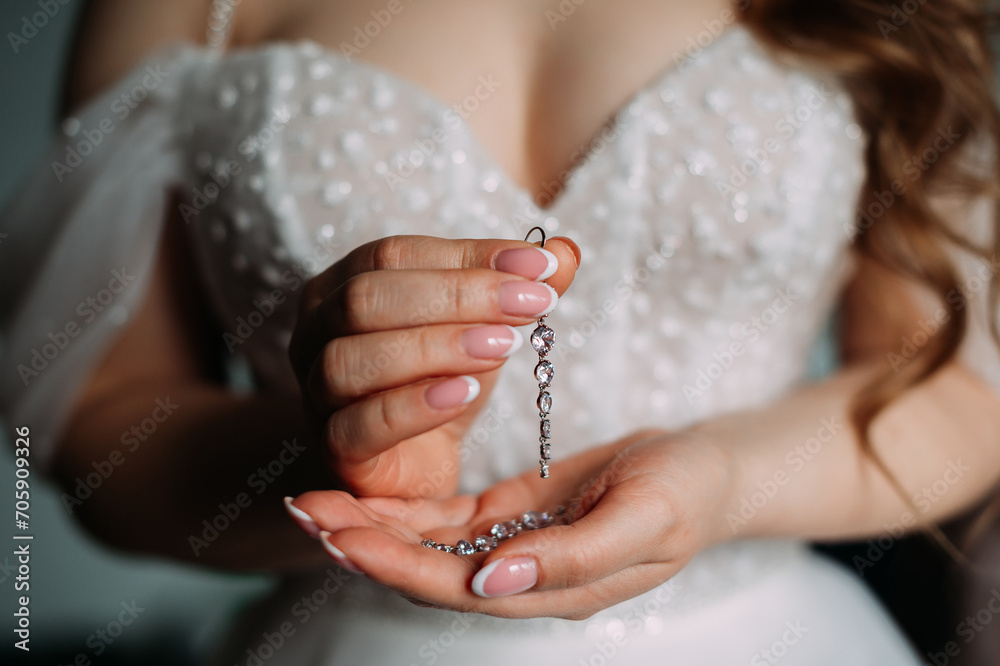 A close-up of a person's hands holding a ring. 5369