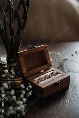 A wooden box with a key on top of it, placed on a table 5380.