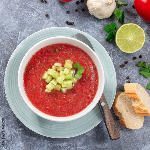 Soup Gazpacho garnished with cucumber and cilantro, in bowl, top view, square format