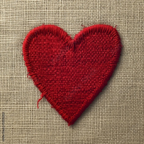 red embroidered heart on a beige canvas 