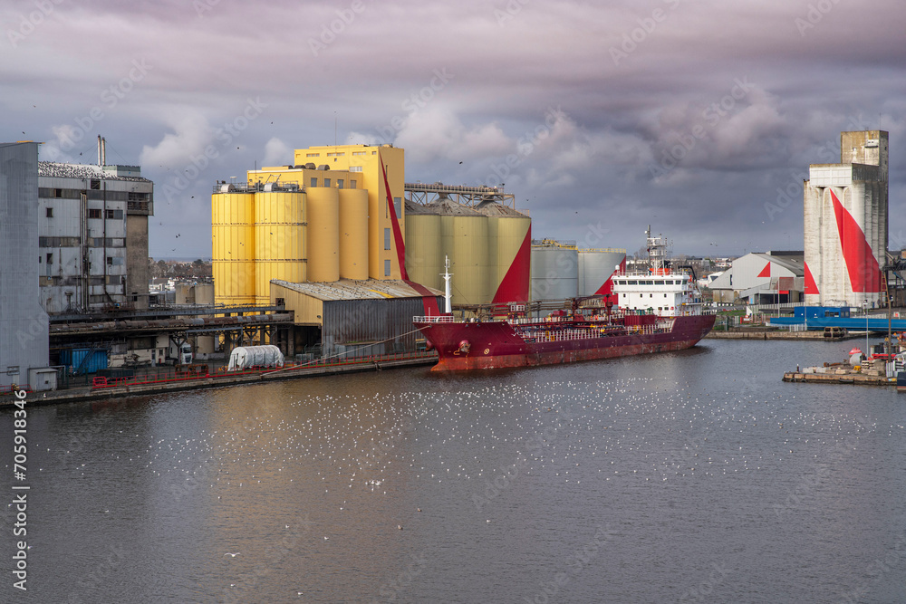 Boat and grain silo in the port of Saint-Nazaire in Brittany, France

