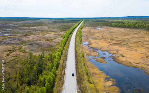 Road leading through wetland of finnish Lapland above the arctic circle