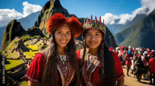 Peruvian women in national clothes against the background of Machu Picchu in Peru, ancient architecture, South American Indian, dark elderly girls in a hat and woolen poncho, tourism, travel © Julia Zarubina