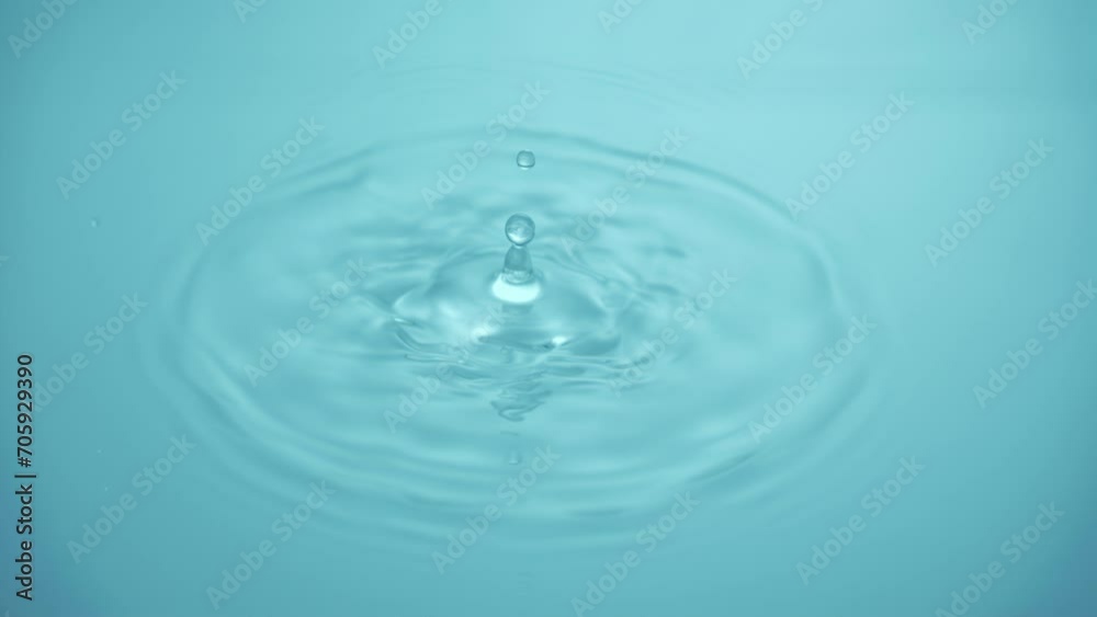 Natural mineral water splashing. Crystal clear drop of cosmetic essence serum falling in slow motion. Body moisturizing cosmetics formulating. Commercial beauty product blue liquid abstract background Natural mineral water splashing. Crystal clear drop of cosmetic essence serum falling in slow motion. Body moisturizing cosmetics formulating. Commercial beauty product blue liquid abstract background