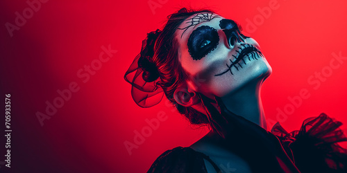 Stylish woman with halloween make up posing isolated on dark red background with red neon light effect with copy space for text.