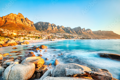 Cape Town Sunset over Camps Bay Beach with Table Mountain and Twelve Apostles in the Background photo