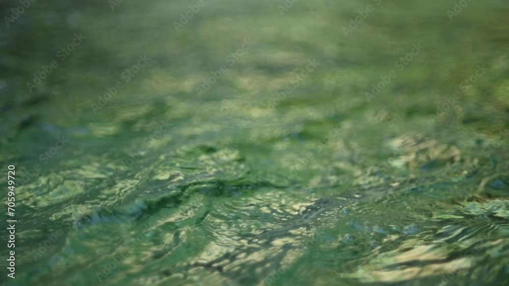 Green waves on the pond of a mountain stream (abstract, slow motion) Green waves on the pond of a mountain stream (abstract, slow motion)