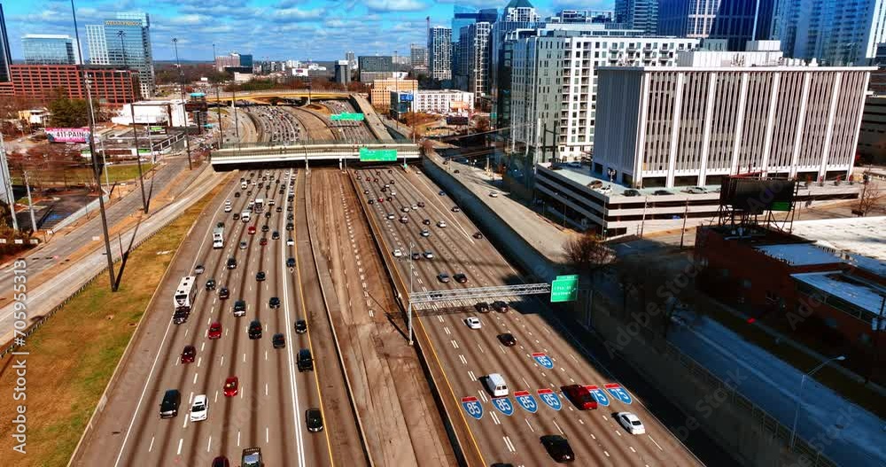 Multiple vehicles moving by the wide roads of Atlanta, Georgia, USA. Top view on city downtown on sunny daytime. Multiple vehicles moving by the wide roads of Atlanta, Georgia, USA. Top view on city downtown on sunny daytime.