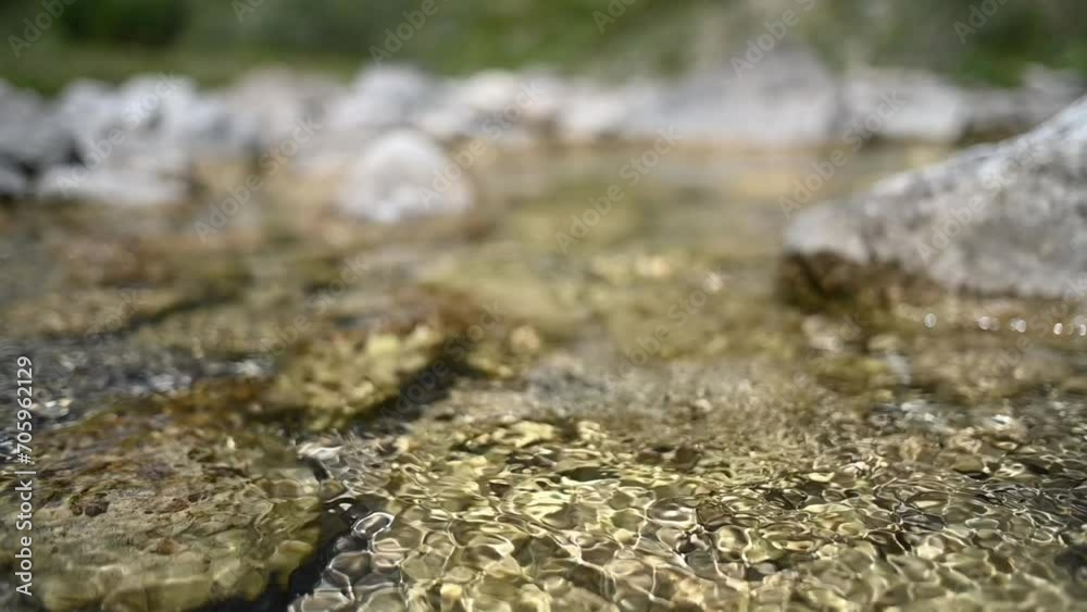 Abstract shot of water running over stones from a mountain stream (slow motion) Abstract shot of water running over stones from a mountain stream (slow motion)