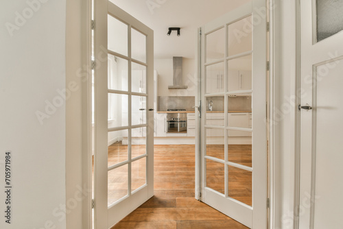 Kitchen seen through open white door photo