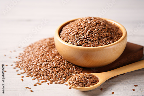a bowl of brown flax seeds and a spoon