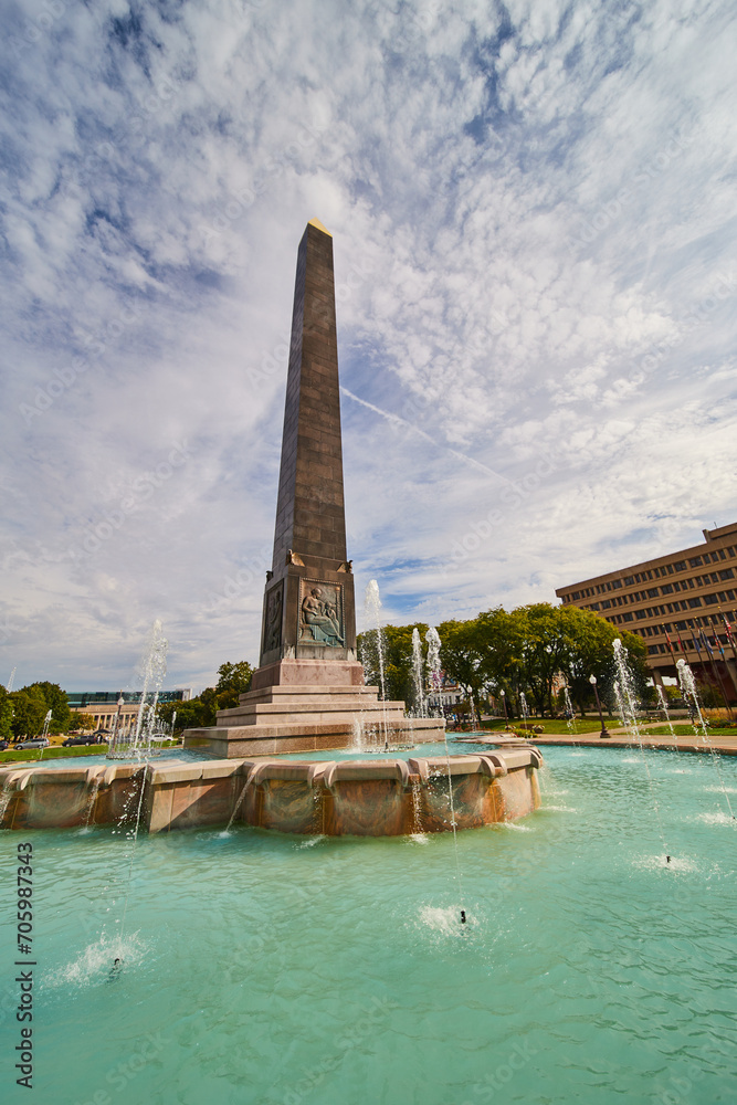 Grand Obelisk Monument with Fountain in Urban Park, Low Angle View