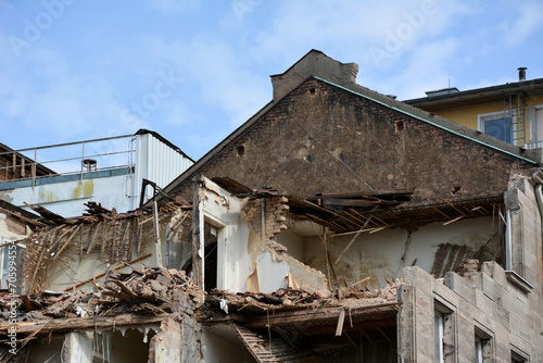 The construction site with the dismantling of the walls of the building on the street of the city. Reconstruction and renovation of cities
