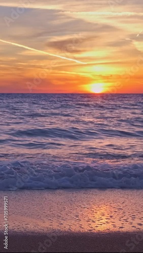 Colorful sunset over sea horizon, summer, low sun, tidal waves in close-up