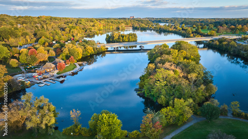 Fototapeta Naklejka Na Ścianę i Meble -  Aerial Autumn Glow Over Kayak-Lined Park and Bridge, Gallup Park, Michigan