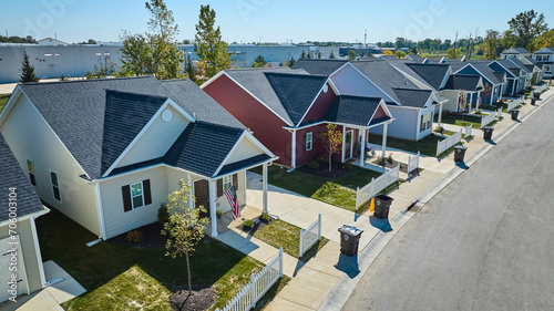 Bild auf Leinwand Aerial View of Colorful Suburban Homes with Neat Lawns and Porches