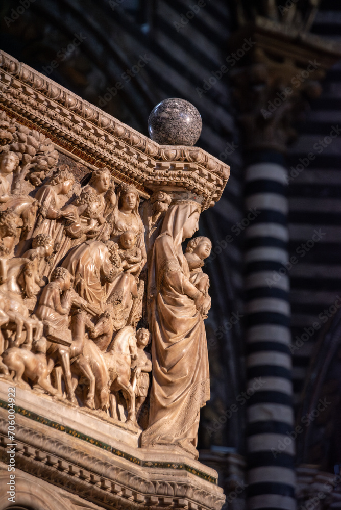 Fototapeta premium SIENA, ITALY - SEPTEMBER 23, 2023 - Mother mary with child at the marble pulpit in the Siena cathedral, designed by Niccolo Pisano